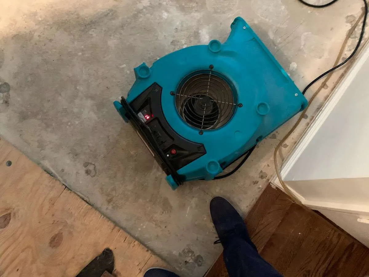 Air mover drying subfloor during Leak Detection & Repair in Winchendon